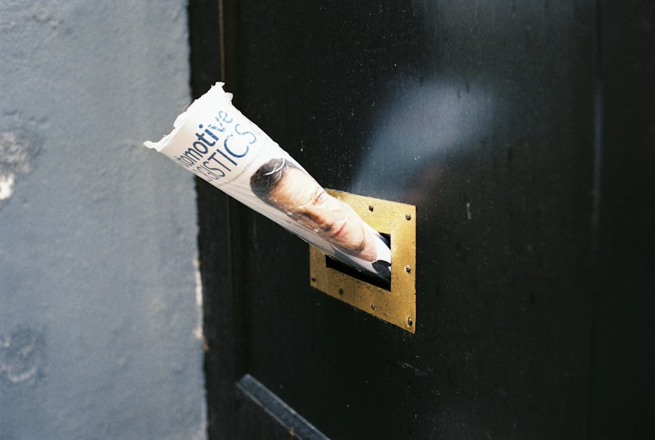 Direct mail marketing materials securely delivered through door mail slot for targeted outreach campaigns.